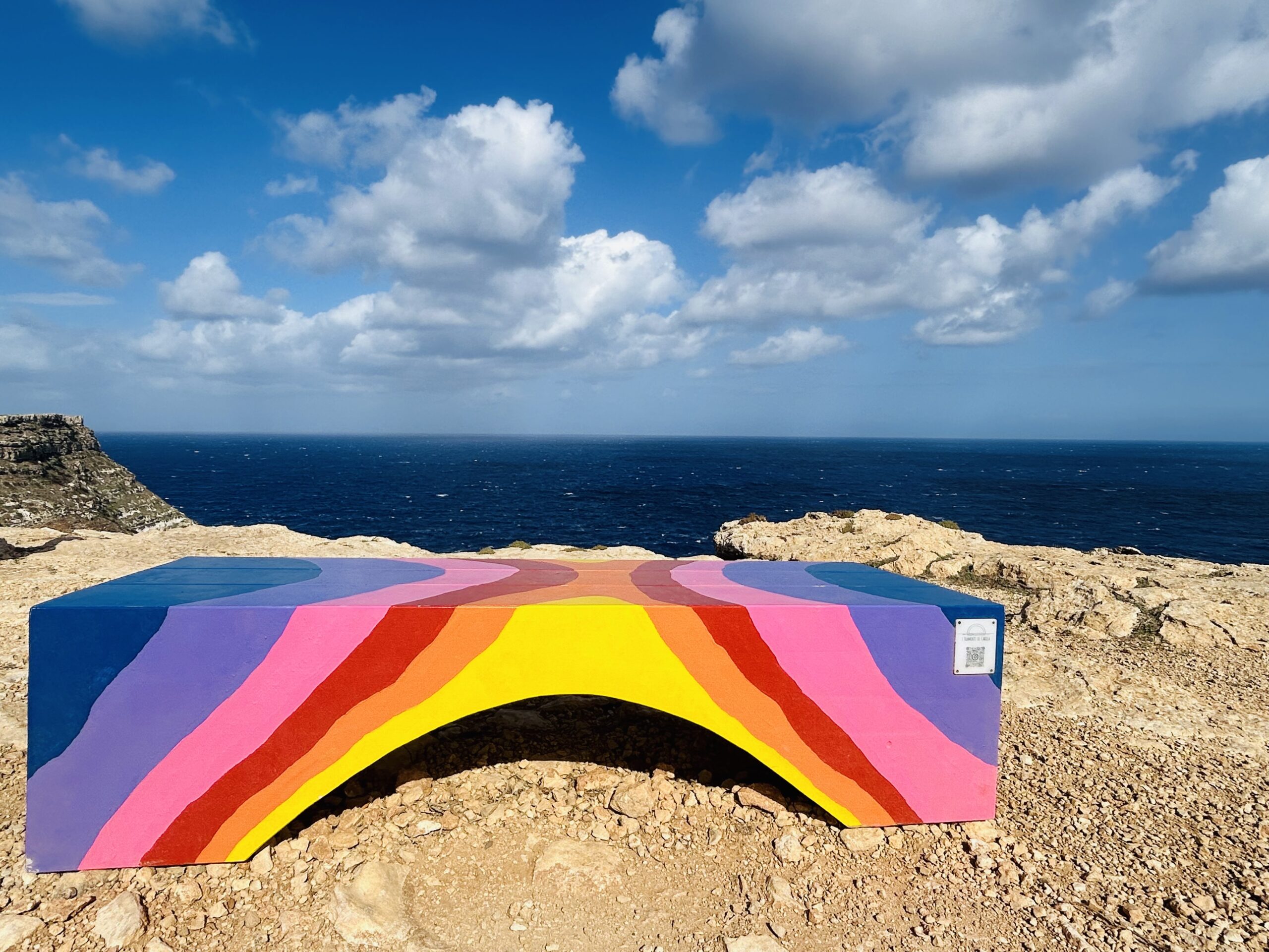 A coloured bench, the sea and the horizon in Lampedusa